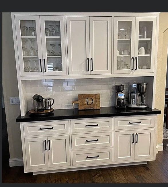 White built-in hutch with glass-front cabinets and a coffee station