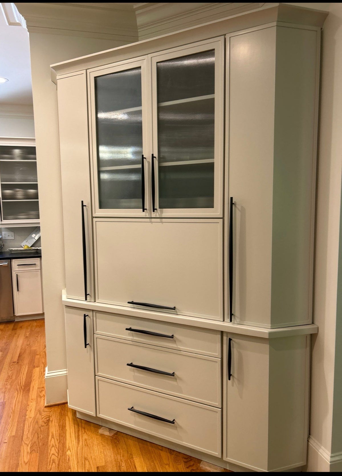 Tall sage green cabinet hutch with glass doors and drawers